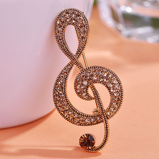 Broche note de musique vintage en métal doré