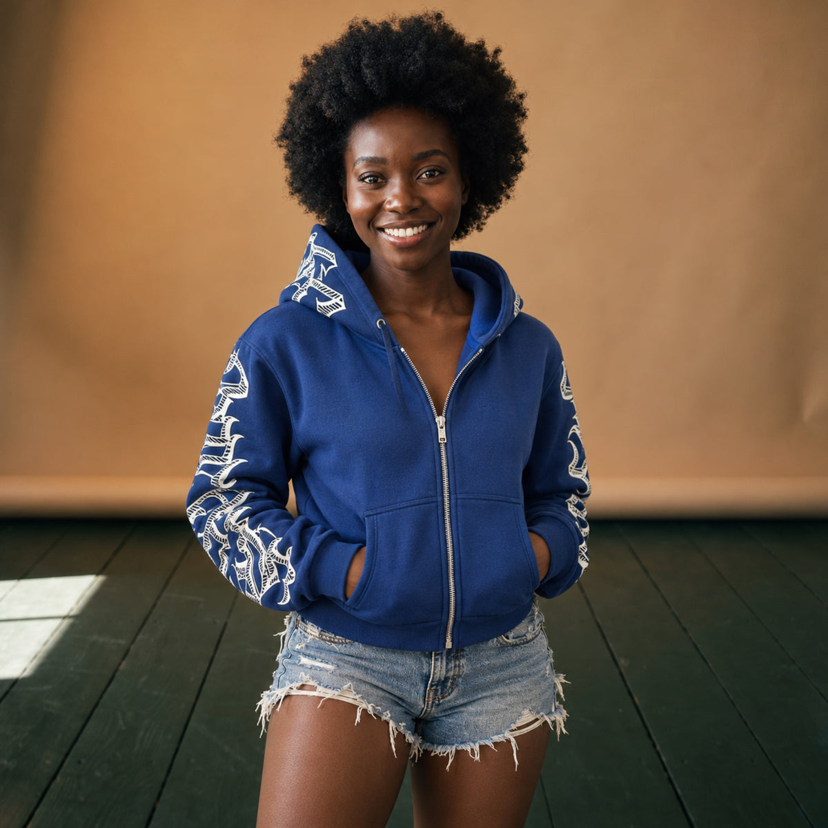 Sweat à capuche femme vintage bleu zippé à lettrage blanc porté en studio, capuche relevée Image